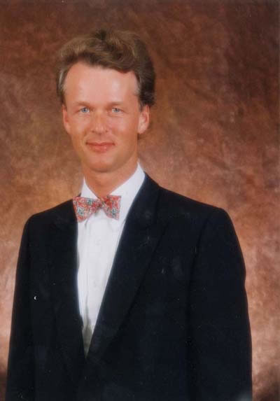 Jon England - formal portrait in black suit