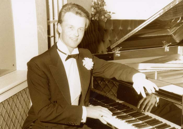 Jon England performing at piano