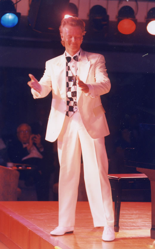 Jon England on stage in sparkly performance costume