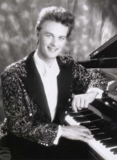 Jon England in sequined outfit at the piano